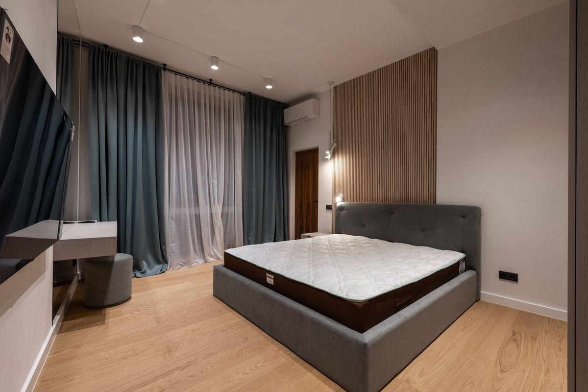 Light LVP-style flooring in a modern bedroom